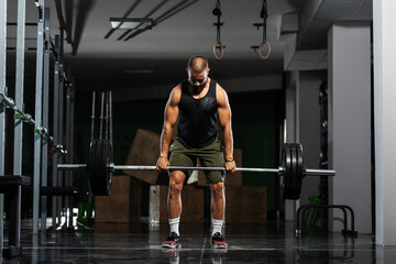 Obraz na płótnie Canvas Muscular athlete lifting very heavy barbell