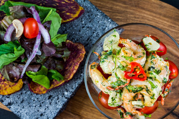 roasted shrimps with parsley and garlic, chili, tomato with lemon and salad
