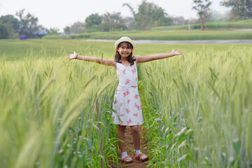 Happy girl in the barley field A growing green