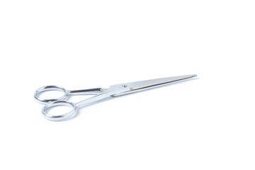 Silver metal scissors for haircut on white background.