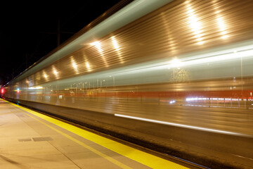 Fototapeta na wymiar Train Passing Terminus in San Francisco Bay Area at Night