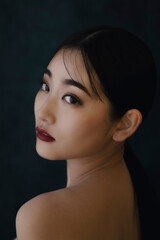 Portrait of a beautiful woman with a long black hair.
