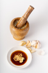 Wood-mashed garlic on a pure white background