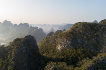 Aerial view of beatiful sunrise over karst mountain peak landscape