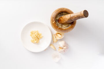 Fototapeta na wymiar Wood-mashed garlic on a pure white background
