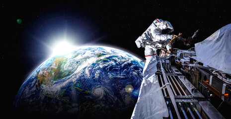 Astronaut spaceman do spacewalk while working for space station in outer space . Astronaut wear full spacesuit for space operation . Elements of this image furnished by NASA space astronaut photos. © InfiniteFlow