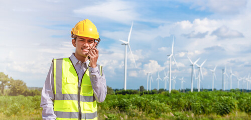 portriat of young engineer asian male hand holding two way radio and smiling with the background of...