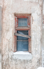 Fototapeta na wymiar Window Old Abandoned Building in Winter in Former Soviet Republic