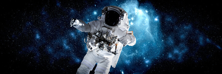 Astronaut spaceman do spacewalk while working for space station in outer space . Astronaut wear...