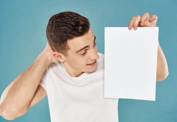 man with flyer in hand and mockup blue background cropped view