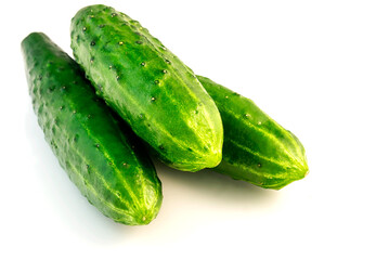 Three fresh green cucumbers on an isolated white background. 