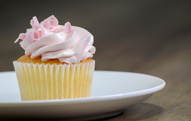 Vanilla and strawberry cupcake on the table