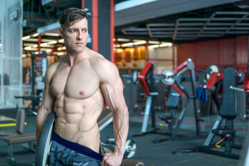 Fototapeta na wymiar Shredded fitness model in the gym