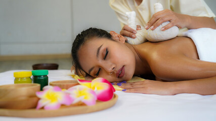 Beautiful Asian woman laying her body to relax in an oil spa massage in the salon. woman relaxing in spa.