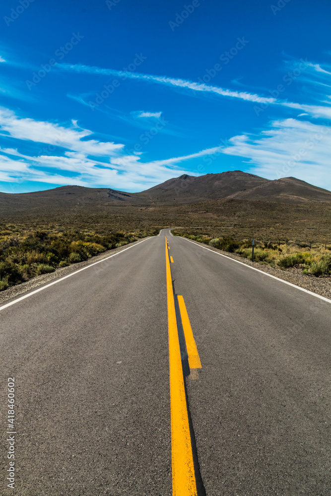 Wall mural dramatic empty and lonely back road in the california desert.