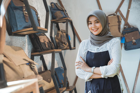 Portrait Of Asian Muslim Business Owner Standing In Front Of His Bag Store With Tablet