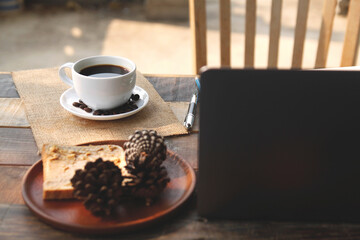 cup of coffee beans on wooden table