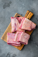 Raw Organic Beef Short Ribs Ready to Cook, on gray stone background, top view flat lay