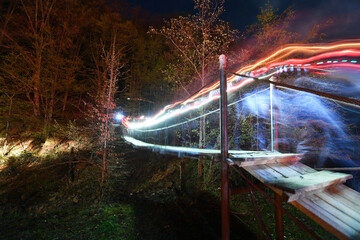  Lights of lanterns at night on a bridge in the woods. Night photography.