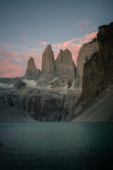 Torres del Paine at sunrise, with rose clouds and blue water