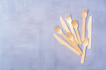 Eco Friendly Disposable tableware from natural materials. Wooden cutlery on natural gray stone background. Top view copy space