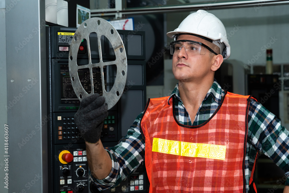 Poster smart factory job worker looking at machine part in manufacturing workshop . industry and engineerin