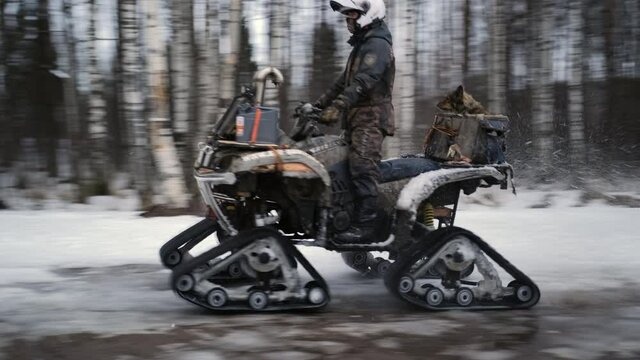 Men on a snowmobile and ATVs ride along the forest at high speed