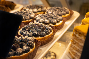 Pastry shop with variety of donuts, muffins, creme brulee, cakes