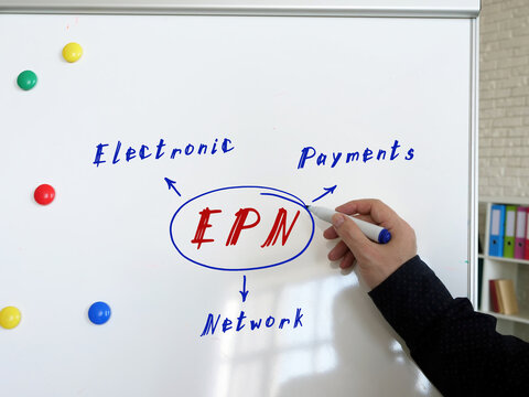 Text EPN Electronic Payments Network on Concept photo. Young bussines man in a suit writing on the white board.