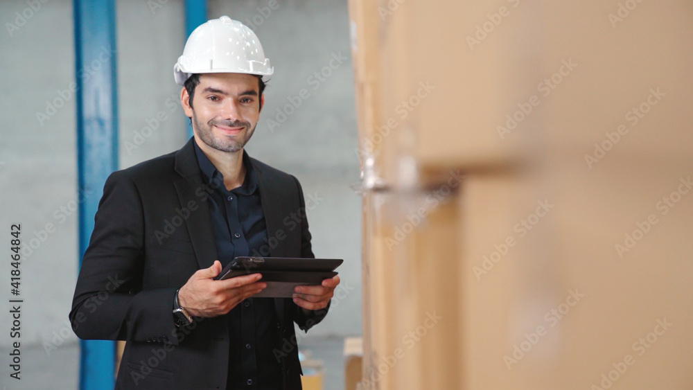 Poster factory manager using tablet computer in warehouse or factory . industry and supply chain management