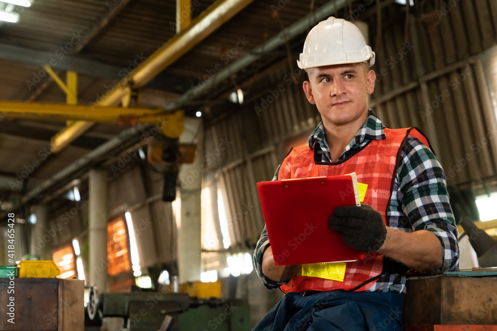 Poster manufacturing worker working with clipboard to do job procedure checklist . factory production line 