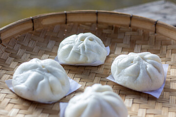 Steamed bun on bamboo basket in morning closeup focus corner