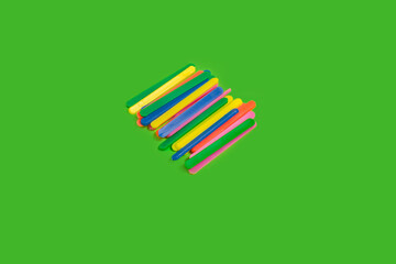 multicolored counting sticks on a green background