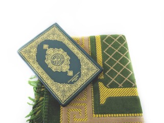 Blurred Photos of the Koran and prayer rugs ready for Ramadan.  Arabic on the cover is translated...