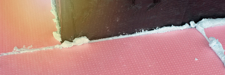Construction foam between pink extruded styrofoam sheets