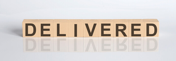 Delivered Word Written In Wooden Cube on white background