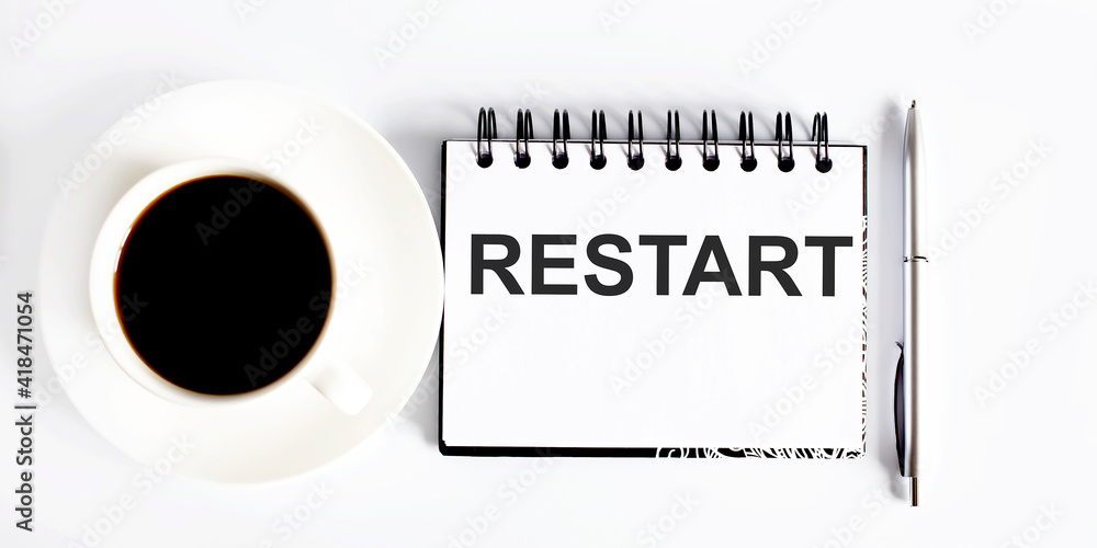 Poster text restart , planning concept. notebook with text on white background with coffee