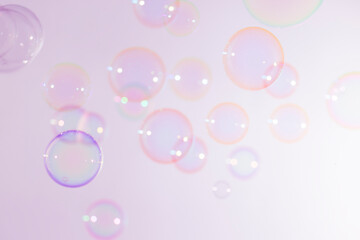 Beautiful Blur Transparent Colorful Pink Soap Bubbles Floating Background.