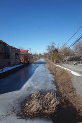 Canal in Winter Snow Slush Ice Buildings