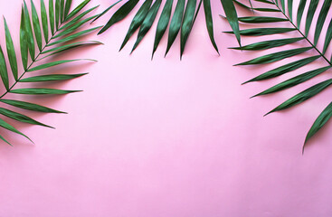 palm leaves background on pink, summer leaves frame tropic flowers with copy space