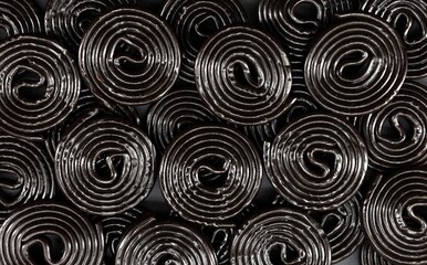 Black wheel licorice candies . Food background and texture.Top view.