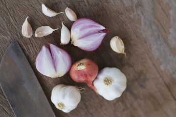 Onion and garlic for cooking on old wooden background