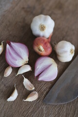 Onion and garlic for cooking on old wooden background