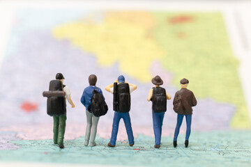 Miniature people Backpacker walking on map Travel and Adventure concepts.