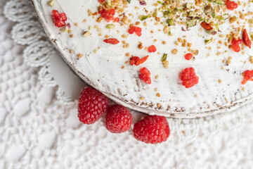 white cream cheese mascarpone cake yogurt cheesecake  with pistachios raspberries  goji sprinkle topping 