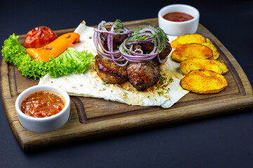 Pork skewers BBQ with onion, grilled veggies and tomato sauce.