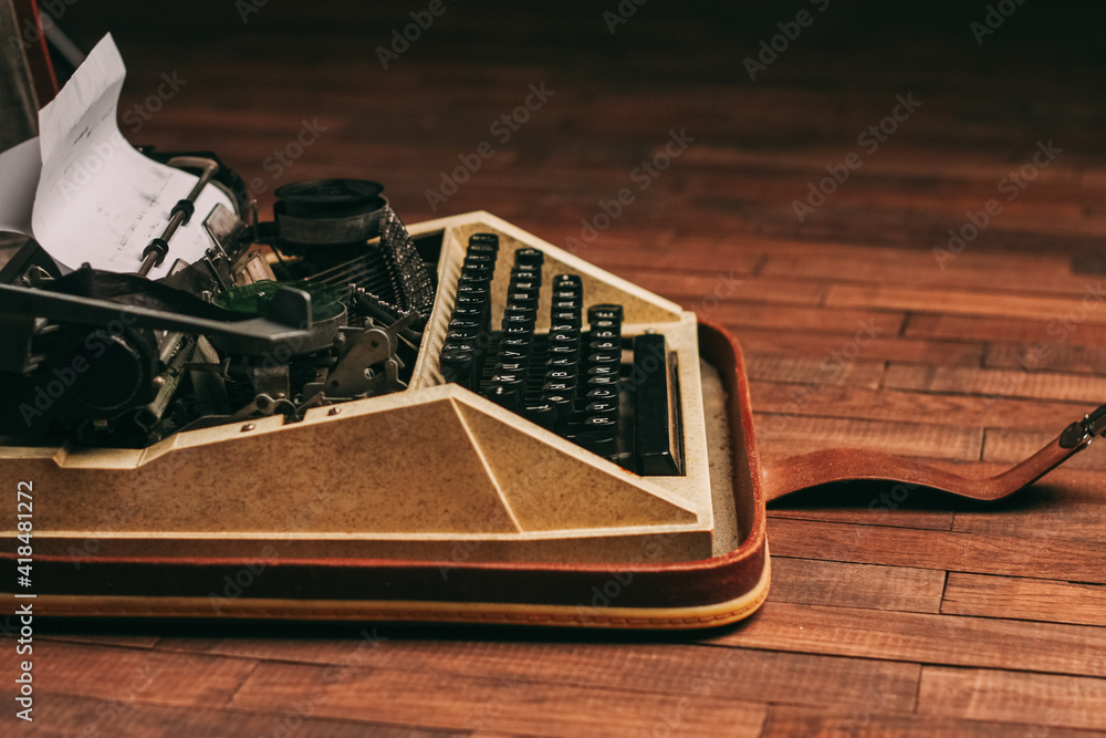 Poster typewriter with keys on a wooden background retro style close-up macro