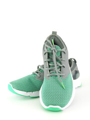 Sneakers in green-gray for exercise and casual wear isolated on a white background..
