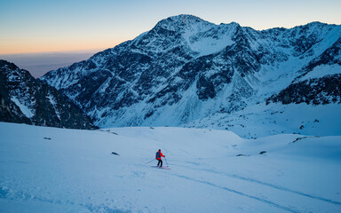 Alpine skiing competition. Sport lifestyle for design concept. Skier slides from the mountain on...