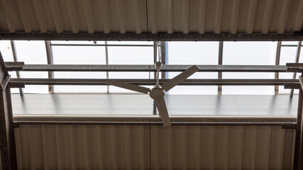 Ceiling fan in a commercial building with skylights